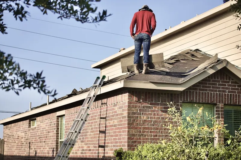 Professional roofer working on a residential roof in Suplee